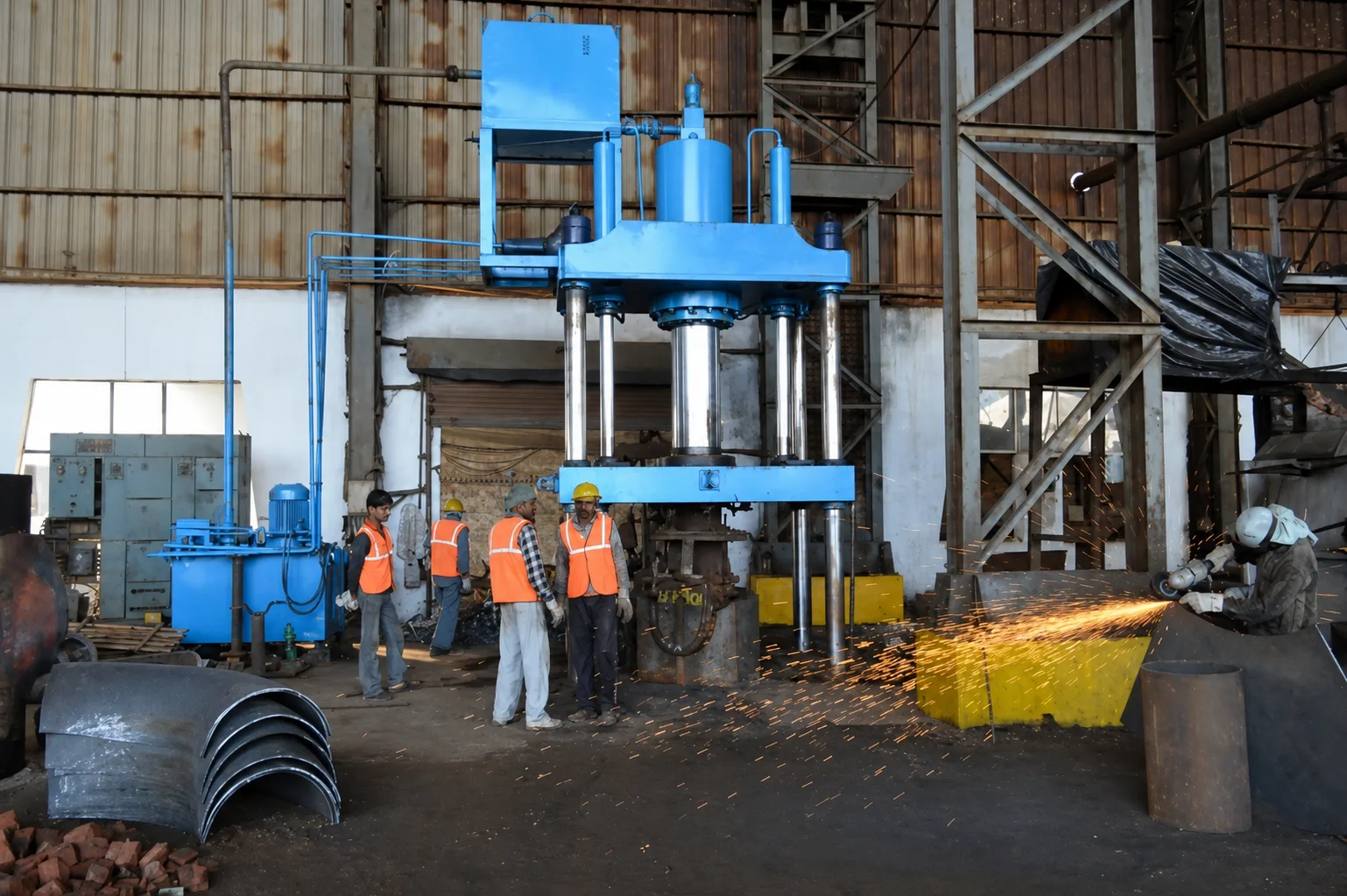 Large-diameter hydraulic press forming line at the manufacturing facility.
