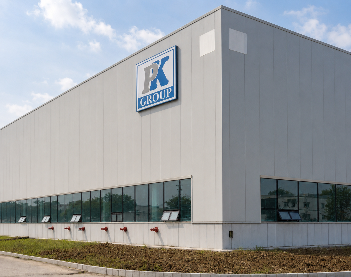 Main P.K. Group manufacturing building with the company logo on the facade