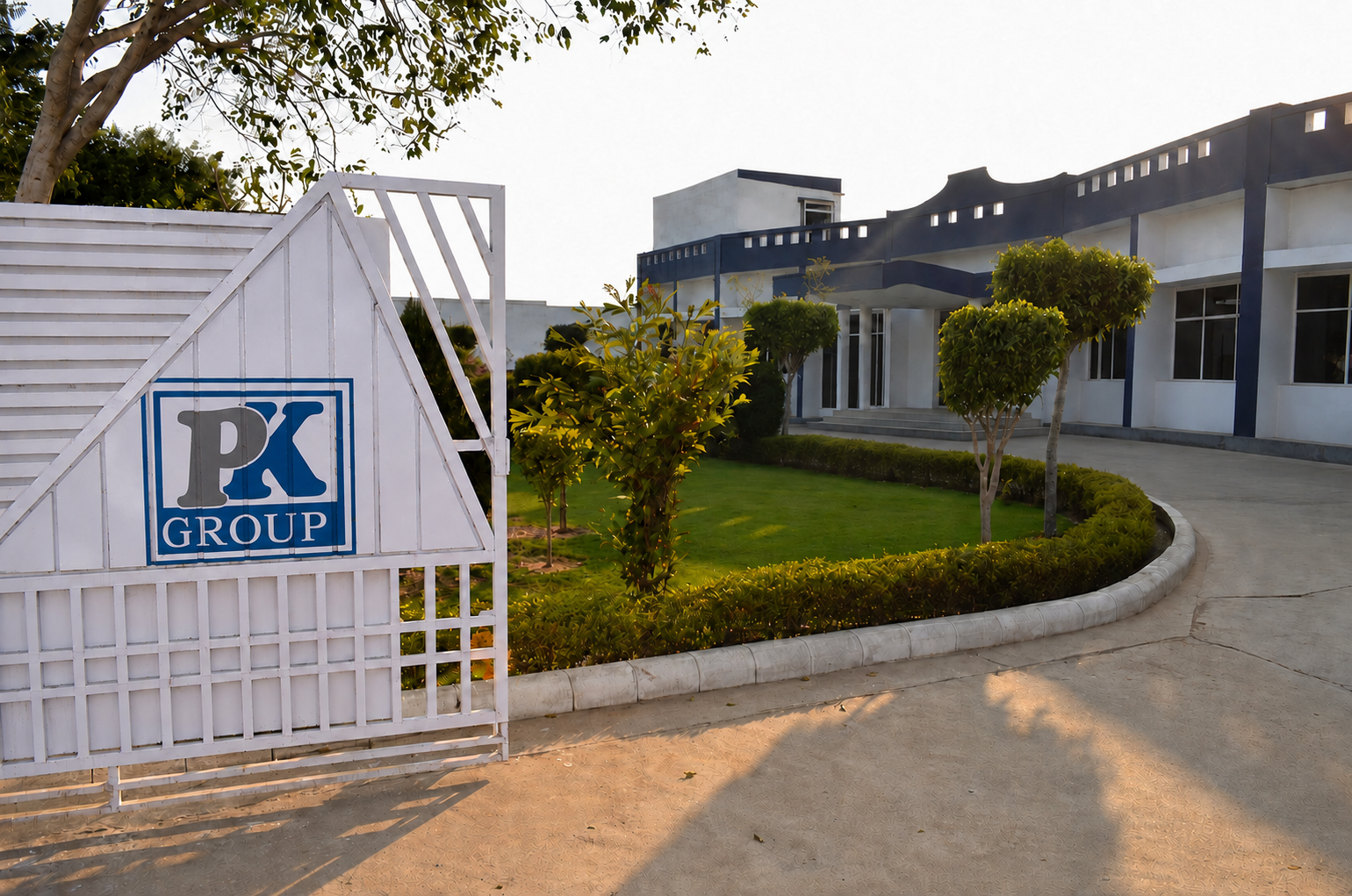 P.K. Group entrance gate with landscaped grounds and administrative building